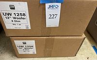 Two sealed brown boxes, each labeled UW 1258 12" Woofer 8 Ohm