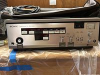 Front view of Sony Betamax recorder showing control buttons and headphone jack with power on indicator.