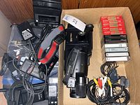 Box with camcorder, remotes, batteries, charger, rewinder, cables, tapes and microphone