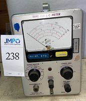 Front panel view showing the analog meter scale, control knobs, and labels of the Type 130 L-C Meter with seller lot tag visible.