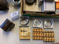 Nikon extension ring Model E2 in box and three additional rings in plastic sleeves