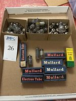 Overview of lot showing three small cardboard compartments with mixed tubes, row of boxed tubes and loose tubes below