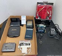 Overview of all items in cardboard tray on black table