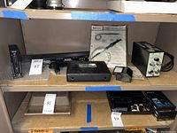 Shelf overview showing multiple audio and test instruments arranged side by side