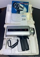 Front view of Yashica Electro 8 LD-6 movie camera in original styrofoam with instruction booklet.