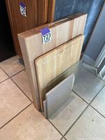 Large thick wooden cutting board and smaller boards arranged side by side showing sizes and shapes.