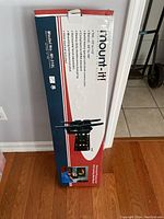 Front of the box showing Mount-It! brand, model number MI-310L, and key features of the TV wall mount.