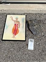 Print and marble clock plaque displayed outdoors on pavement with lot number visible