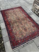 Full view of rug laid flat on patio showing overall shape and pattern