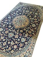 Full view of rug laid flat, showing central medallion and overall pattern