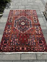 Full top-down view of entire rug on gray pavers