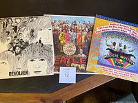 All three Beatles albums shown side by side: Revolver, Sgt. Pepper's Lonely Hearts Club Band, Magical Mystery Tour