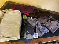 Overview photo showing two pairs of Dockers pants, Lands' End shirts, mitten, wool socks, and boot inserts.