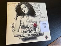 Front cover close-up showing woman with signatures and miniature band figures