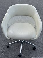Front view of Coalesse SW-1 low back conference chair showing padded seat, mesh back, and chrome base with wheels.