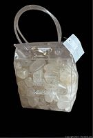 Clear plastic bag filled with clear crystal gemstones showing front with text