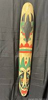 Front view of the full tall tribal mask showing painted carvings and detailed tribal face design