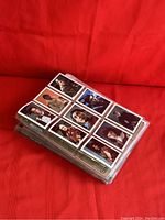 Stack of Star Trek trading cards displayed on a red fabric background, with card fronts showing various character portraits.