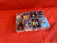 Multiple stacks of Star Trek Episode Collection trading cards in clear plastic protective cases on a red surface.