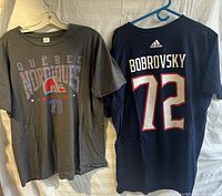 Two NHL themed Adidas t-shirts, one grey Quebec Nordiques with retro logo and number 73, the other navy blue Bobrovsky 72 with Adidas logo.