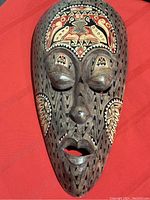 Front view of the large Malacca Malaysian tribal wood mask with intricate painted and carved details