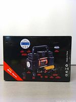 Box front showing air compressor image, digital display with pressure reading, labeled features and handle. Indicates suitability for big tires.