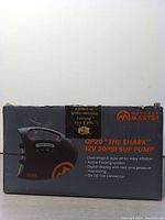 Front view of the Outdoor Master OP20 'The Shark' box showing the pump image, product name, and key features such as dual stage and auto shut off, active cooling, digital display, and 12V DC car connector.