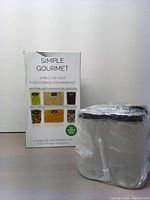 Photo showing 6 clear plastic storage containers sealed in plastic and their product packaging box.