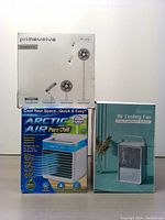Three boxed cooling fans: Primevolve PF-115 portable fan, Arctic Air Pure Chill 2.0 evaporative cooler, Airlysita portable evaporative air cooler