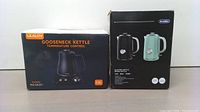 Boxes of Ulalov Gooseneck Kettle and KitchMix Electric Tea Kettle showing front and side labels with specifications and branding.