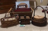 Overview of all items including baskets, picture frames, and wooden box arranged on carpet