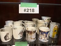 Front view showing entire mug collection including animal-themed and commemorative Royal Worcester mugs