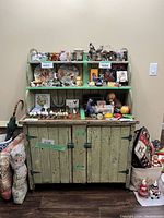 Front view of green painted farmhouse hutch with shelves and cabinet base