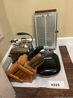 Photo showing wooden knife block with multiple knives, George Foreman grill, stainless steel tea kettle, Salton toaster, Bodeux food warmer.