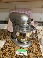 Front view of tilt-head stand mixer with bowl and pouring shield