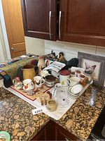 Wide view of all vintage Ridgway Pearsons ceramic and milk glass kitchenware on kitchen counter with quilt and framed art