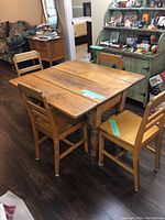 Full view of table and four chairs in room