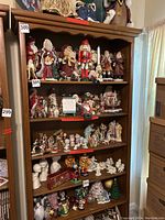 Tall wooden bookshelf filled with Christmas figurines and decorations to show size and shelves.