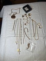 Overview of assorted gold jewelry pieces laid out on table