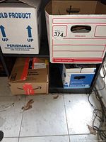 Four cardboard boxes containing radios and accessories