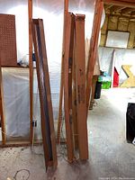 Four long cardboard boxes standing upright in workshop
