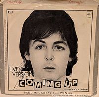 Black and white close-up photo of Paul McCartney on the sleeve of the 'Coming Up' live version 45 RPM single.