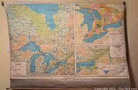 Wide view of large roll-up wall map featuring Ontario and surrounding regions, showing geography and elevation details.