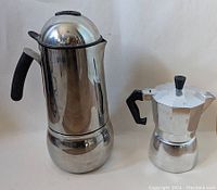 Tall Bialetti and shorter Gnali & Zani stovetop coffee makers side by side, showing overall form and size difference