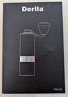 Black box packaging labeled 'Derlla' with an outline drawing of the pepper mill and handle. Box indicates color 'Black'.