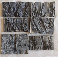 Photo showing all six metal molds arranged on a flat surface, displaying soldier figures and weapon cavities.