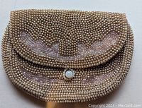 Front view showing flap with pearl button and dusty rose pearl and seed pearl beadwork