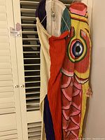 Two fabric windsock kites hanging side by side