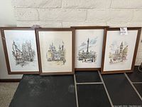 Four framed watercolor prints by Jan Korthals depicting London and Canterbury landmarks, arranged together on floor.