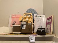 Front view of Juki MO-134 overlock sewing machine, with accessories, manuals, and thread spools around it.